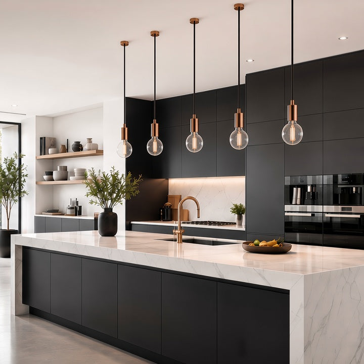 A modern kitchen interior with matte black cabinetry, a white marble island, copper-toned pendant lights, built-in appliances, and large windows overlooking greenery.